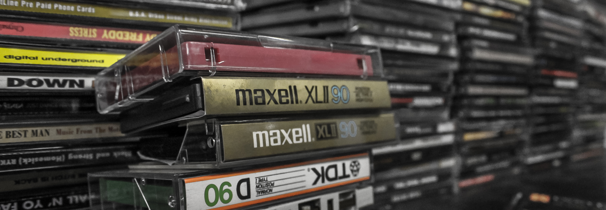 stack of blank tapes in foreground, stacks of CDs in background